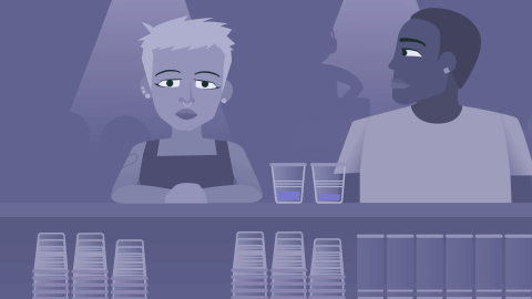 Two people at the bar in a nightclub.