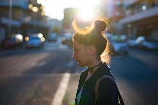 Girl crossing city street.